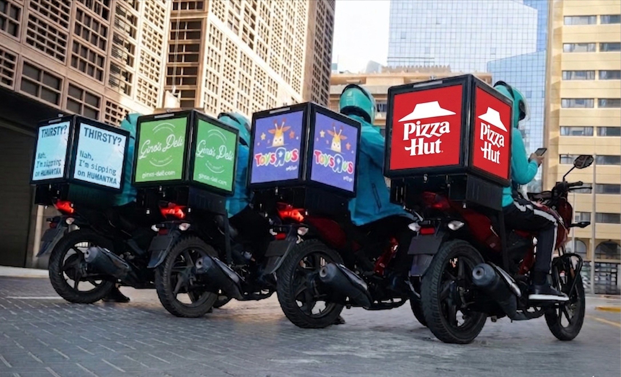 Fleet of delivery riders with Vertbox LED displays showing various brand advertisements